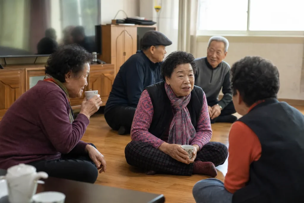 경로당 마루에 둘러앉아 이야기를 나누는 어르신들. (Elderly Koreans sitting together talking at a neighborhood senior hall)